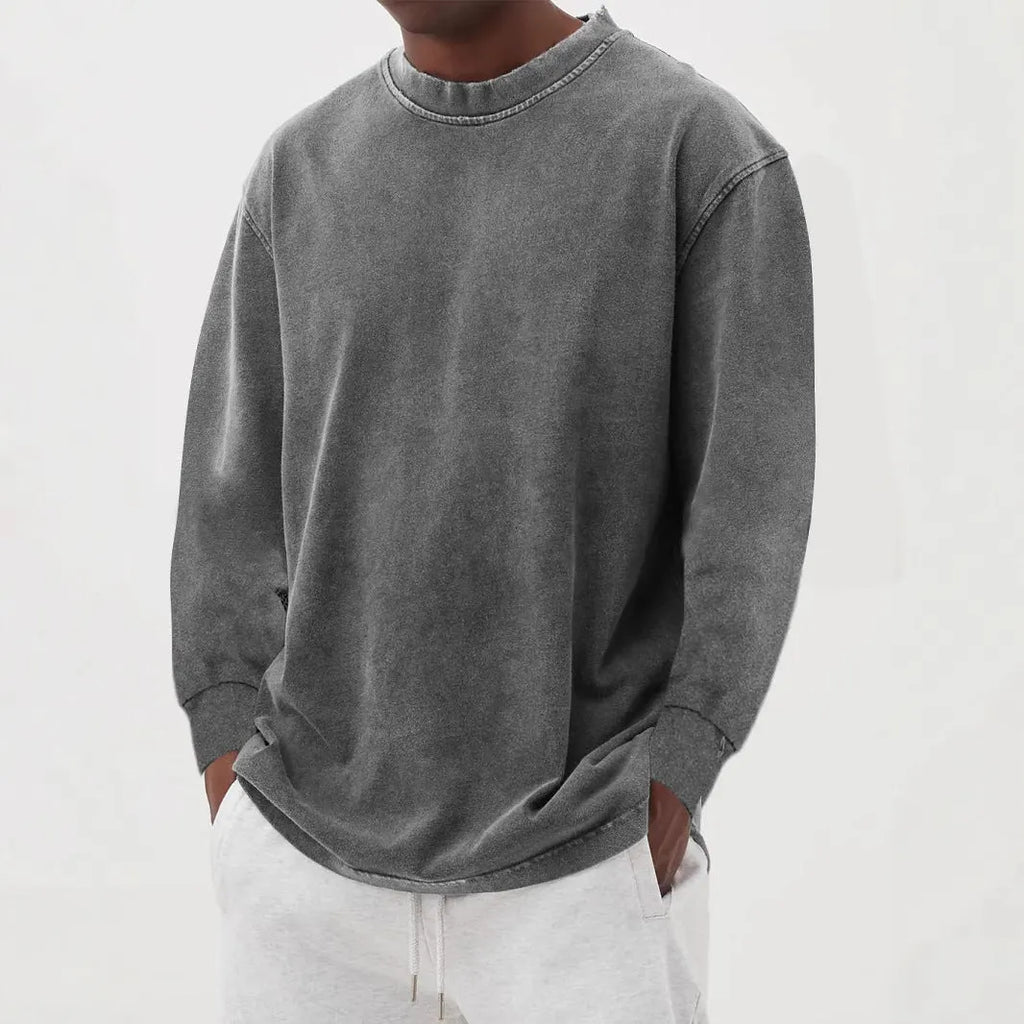 Man wearing a slim fit long sleeve t-shirt in a solid colour, with options in sky blue, green, gray, black, and camel.