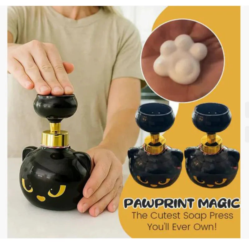 Black plastic cartoon cat shaped foam soap dispenser on a bathroom counter.