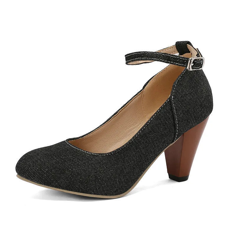 Women's blue denim platform high heels with an ankle buckle and a thick rubber sole.