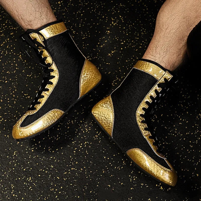 Professional black gold mesh boxing shoes with white leather panels and black detailing, shown in size 42.