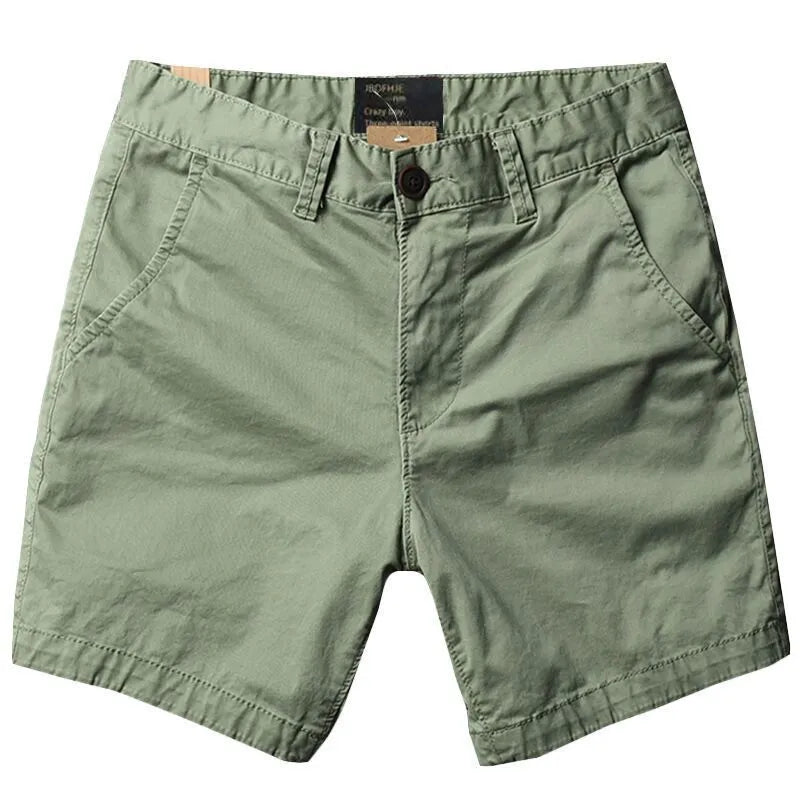 Men's loose straight-leg cotton shorts in solid colours on a hanger