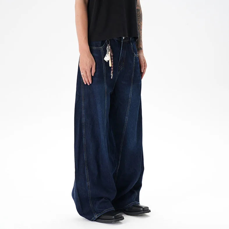 Dark blue wide leg distressed jeans on a hanger showing washed denim fabric and machete cut.