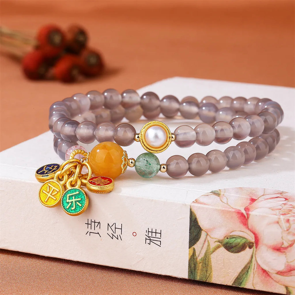 Close-up of a natural grey agate two-circle bracelet with retro design on a wrist.