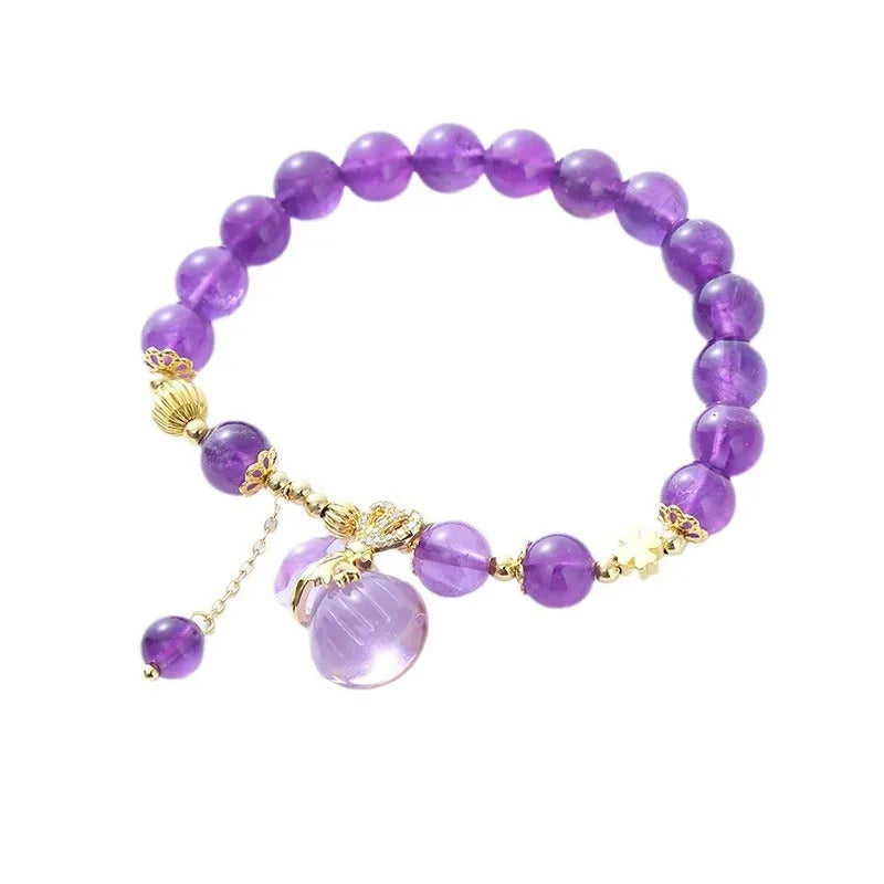Purple crystal bracelet with geometric shapes, money bag pendant and peace buckle on wrist