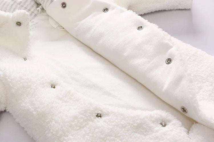 Baby wearing a brown cotton padded winter jumpsuit with long sleeves
