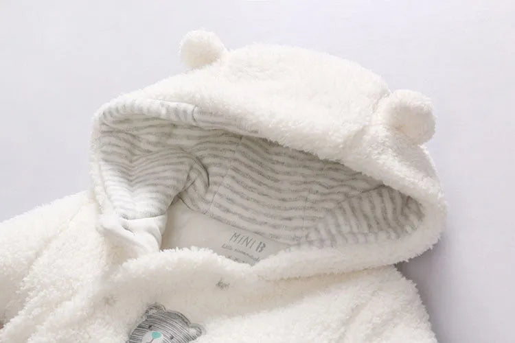 Baby wearing a brown cotton padded winter jumpsuit with long sleeves