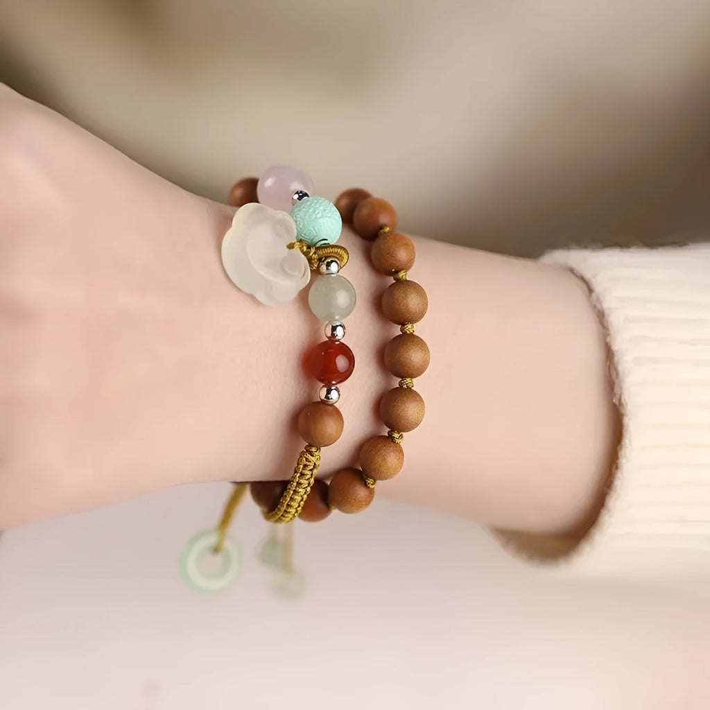 Women's ebony double ring bracelet with hand-woven construction and traditional Ruyi design elements