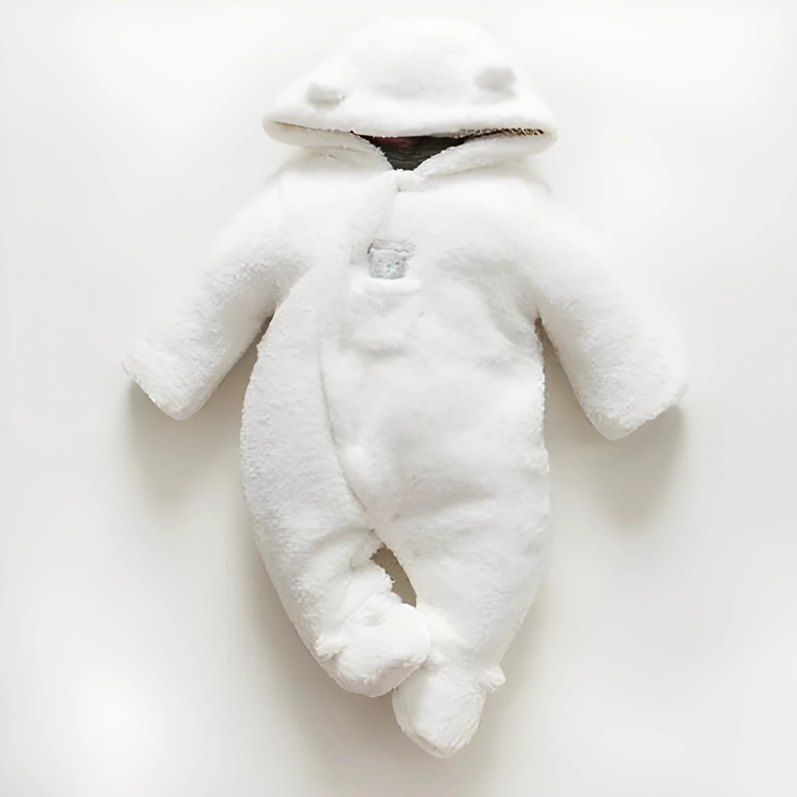 Baby wearing a brown cotton padded winter jumpsuit with long sleeves