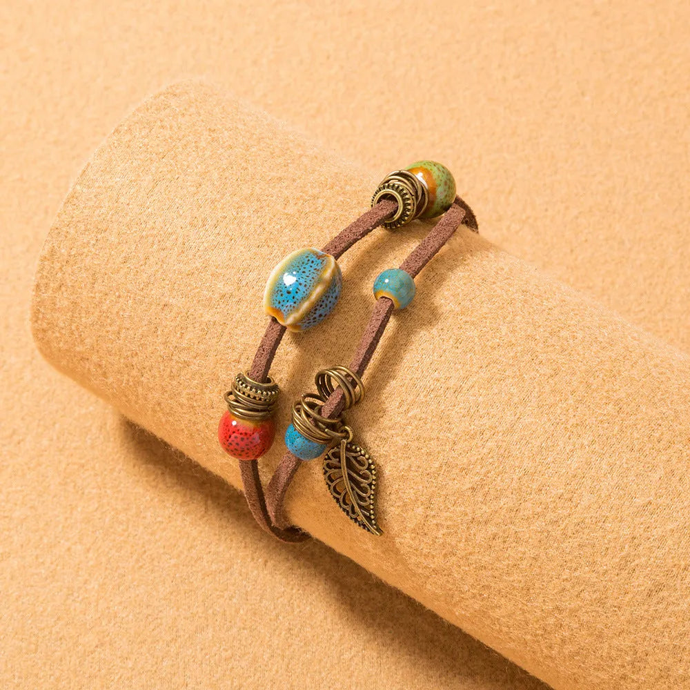 Hand-woven cowhide rope bracelet with ceramic beads in blue or white geometric bohemian style
