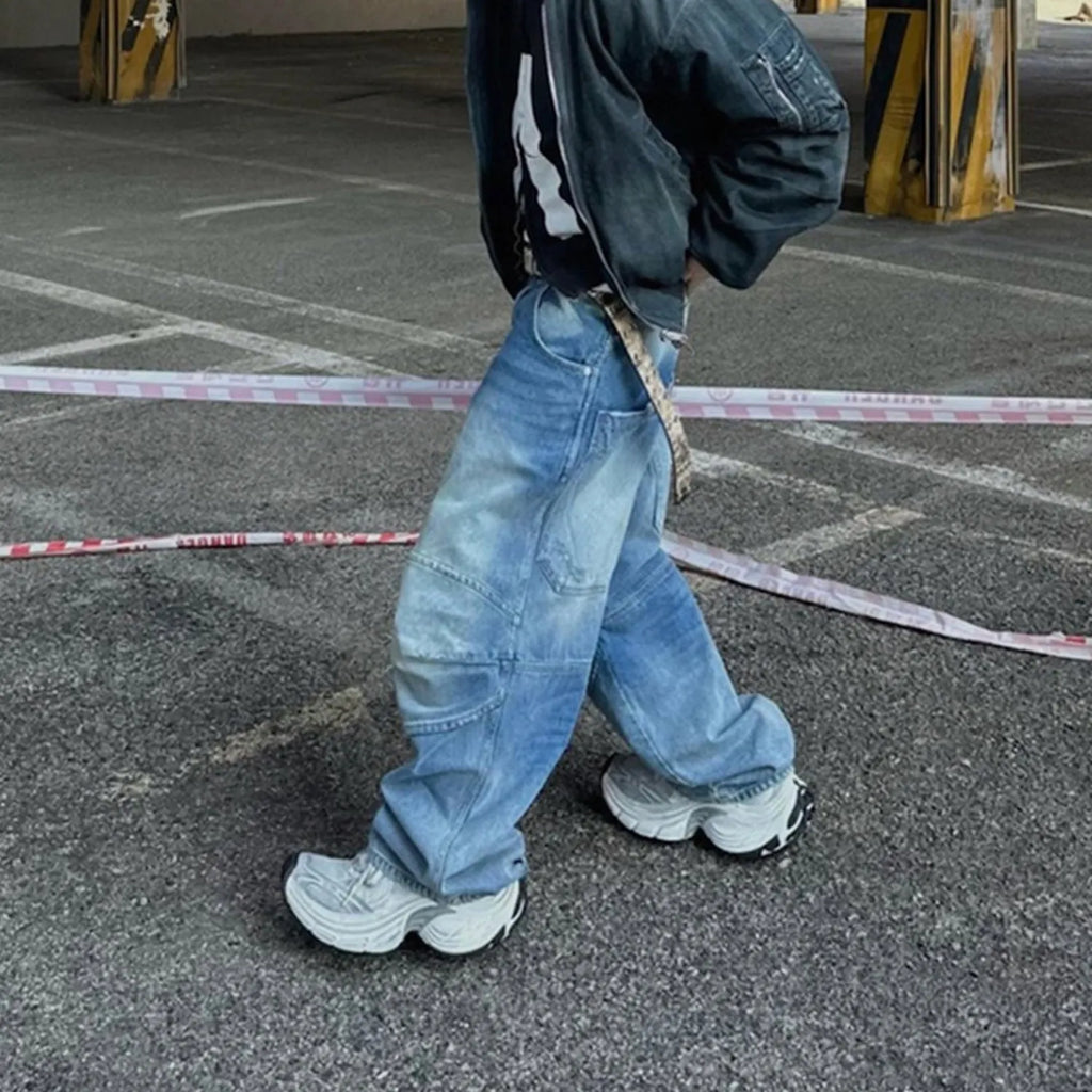 Baggy blue jeans with front pleats and a straight leg, shown in a washed denim finish.