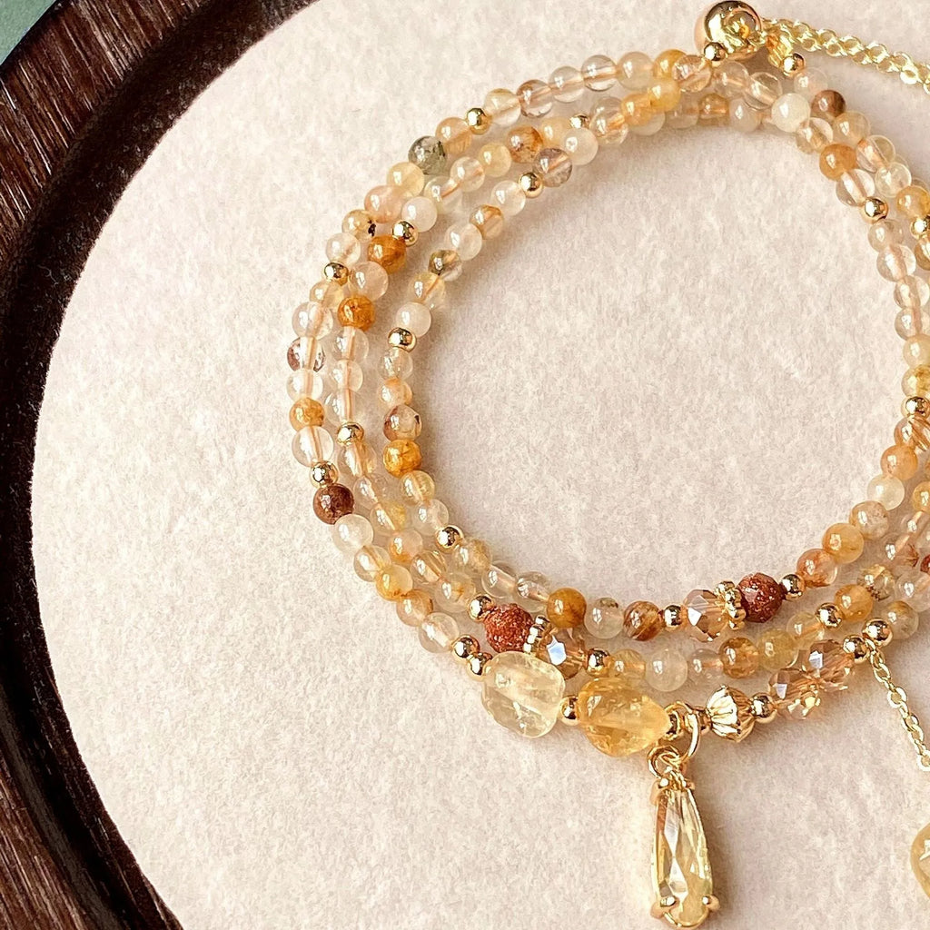 Women's natural citrine crystal bracelet with caramel layers and Saturn ring charm in gold finish