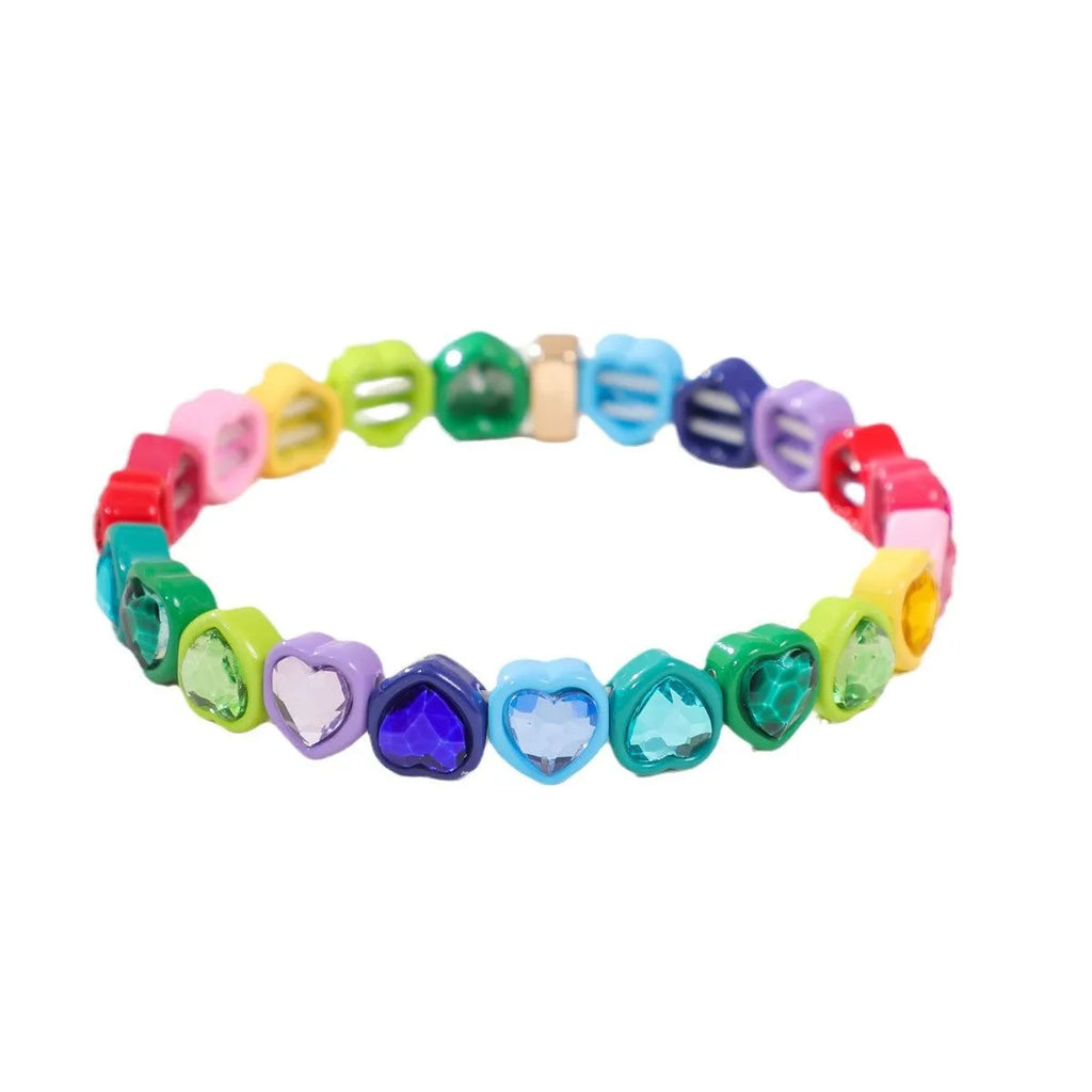 Rainbow enamel heart pendant on a stretch alloy bracelet, shown in multiple colour options.