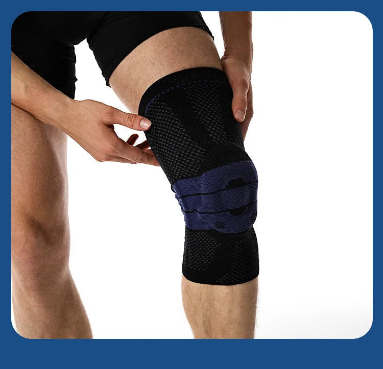 Adult sports knee pad in black and blue colour, made from nylon and spandex, shown on a knee.