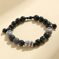 A matching couple bracelet set: one black agate and one white agate bracelet with snake chain clasps.
