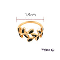 Gold geometric leaf and floral acrylic ring for women on a white background.