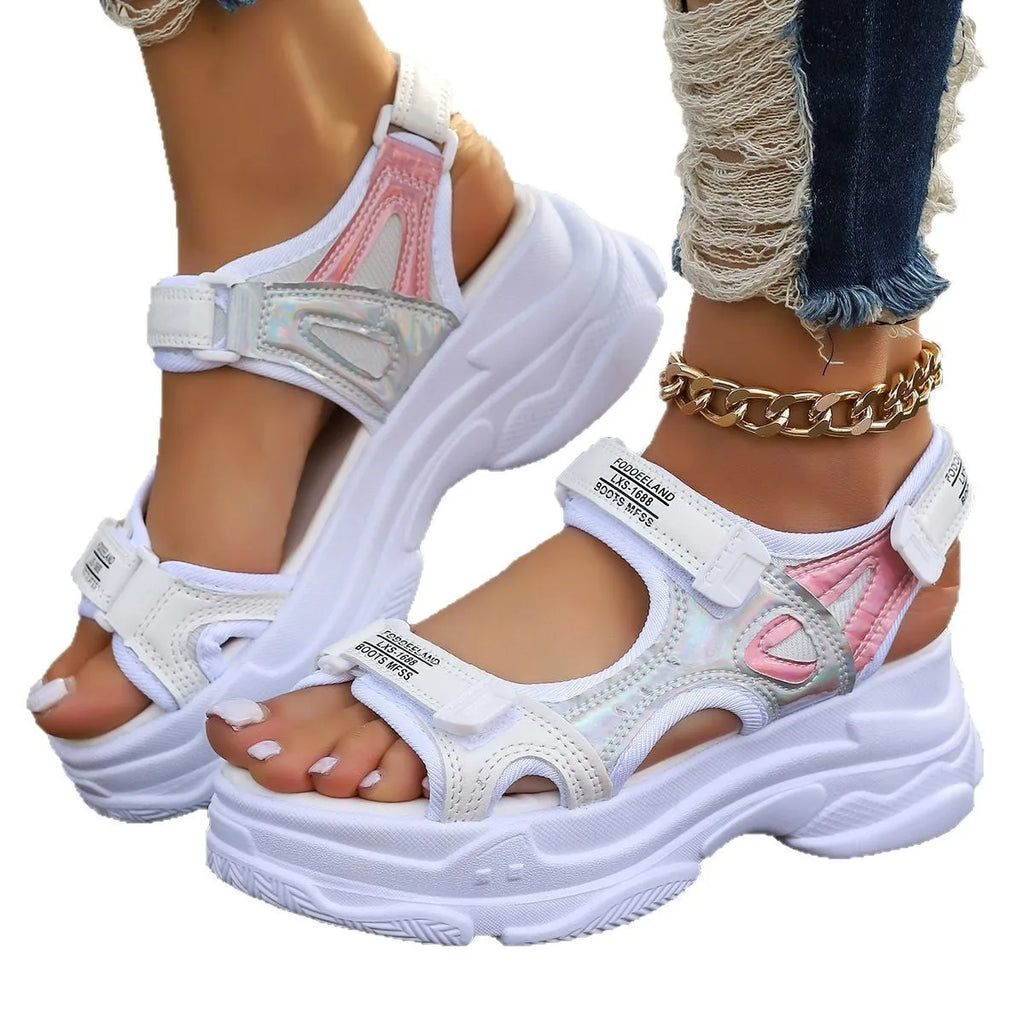 Women's white Roman platform sandals with strap design and rubber sole on a neutral background.