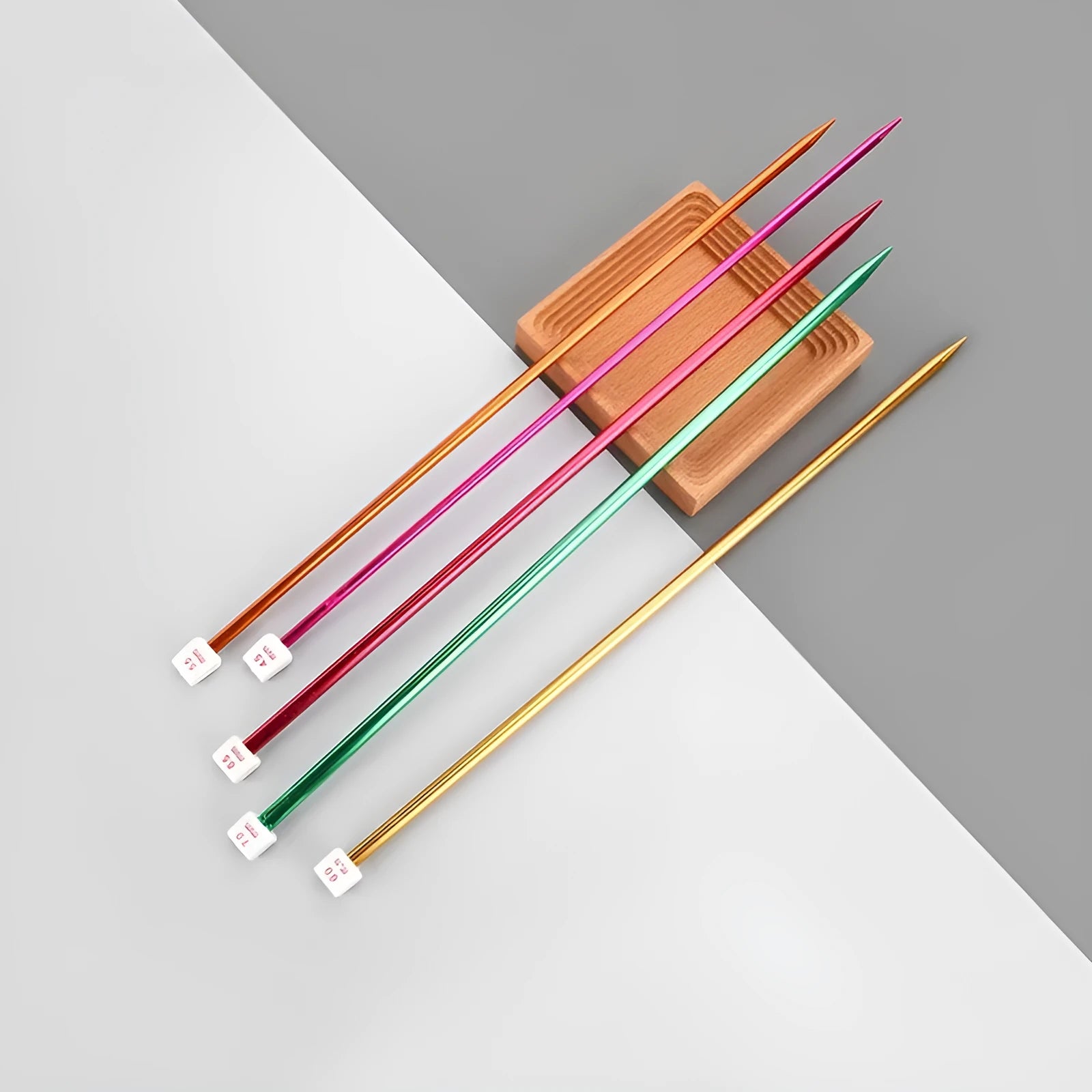 Aluminium lengthened crochet hook set showing multiple sizes with protective caps for knitting crafts