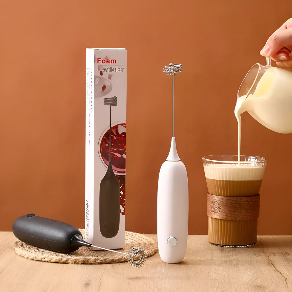 Hand-held electric milk frother and blender in black and white colour options on a kitchen counter.
