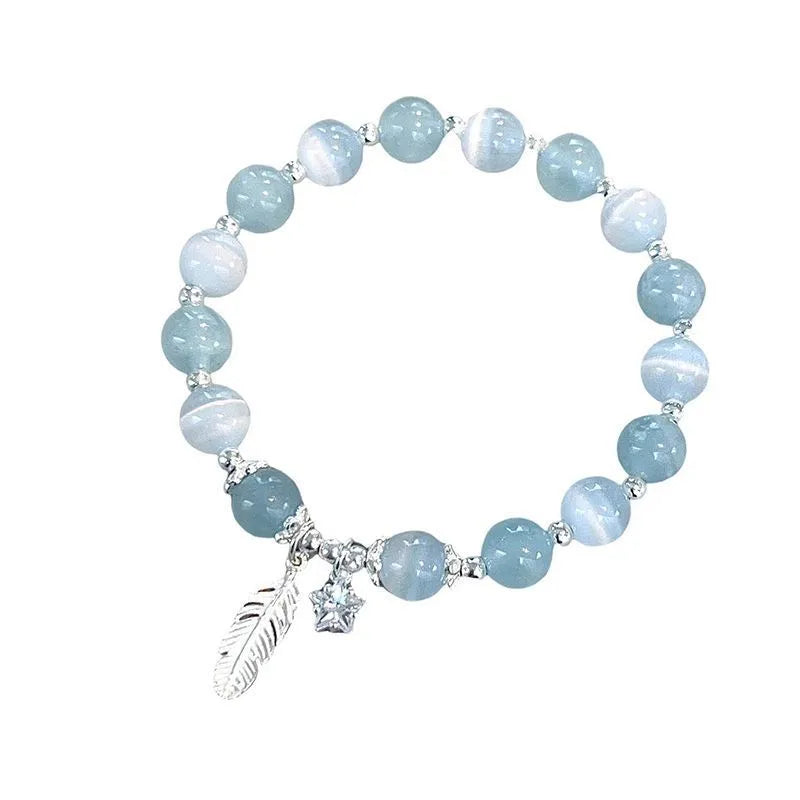 Small white girl crystal bracelet with feather XINGX blue moonlight colour and eight awn star details