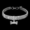 Alloy dog necklace in white with adjustable chain on a light background, three size options available