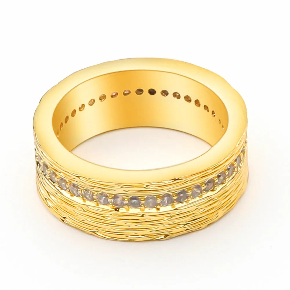 Gold coloured geometric zircon ring for women on a plain background.