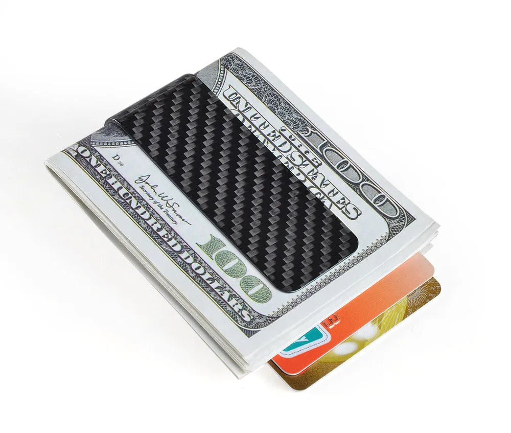 Black glossy striped carbon fibre money clip on a flat surface showing its slim profile and textured pattern