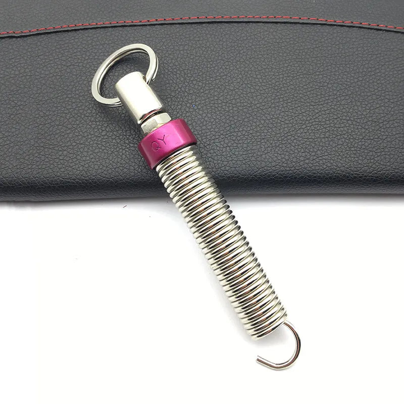 Red car trunk lift spring made from high-strength alloy weighing 130g on a surface