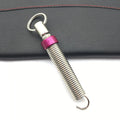 Red car trunk lift spring made from high-strength alloy weighing 130g on a surface