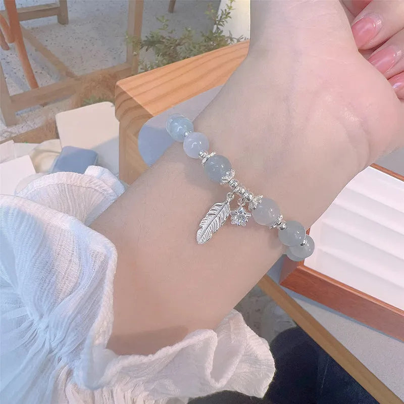 Small white girl crystal bracelet with feather XINGX blue moonlight colour and eight awn star details