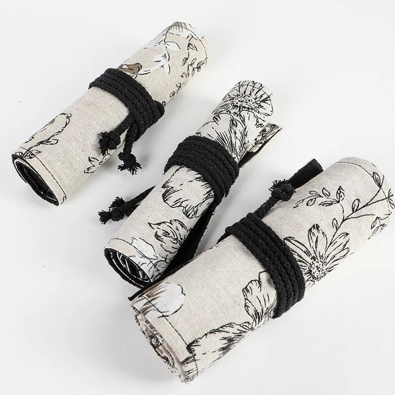 Black Peony floral print canvas pencil roll bag unrolled showing 24 or 72 holes for pencils.