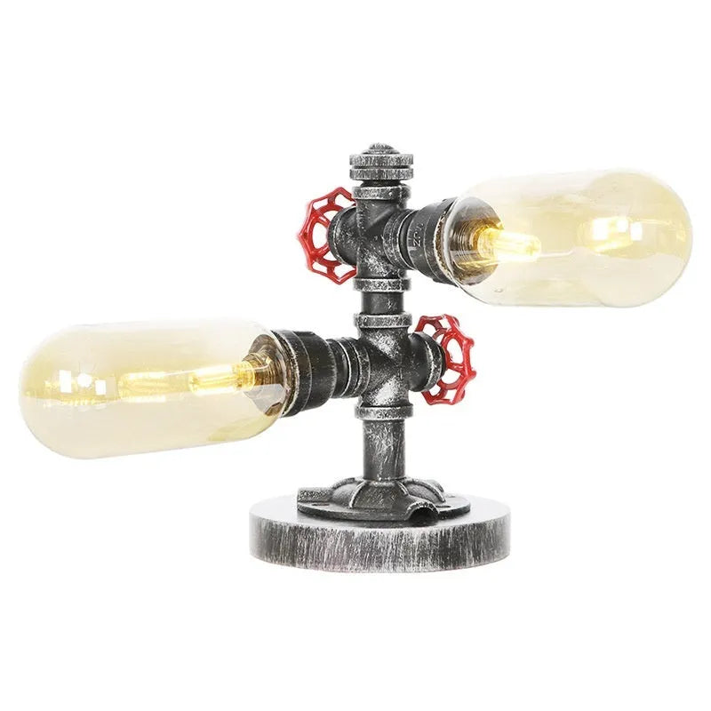 Retro iron art water pipe desk lamp with silver ancient finish on a wooden desk