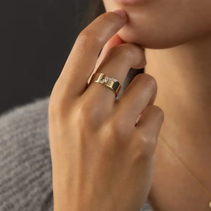 Gold-colour women's ring with zircon centrepiece showing front and side views