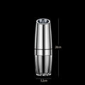 Black and silver rechargeable electric pepper grinder with clear acrylic body on a kitchen counter