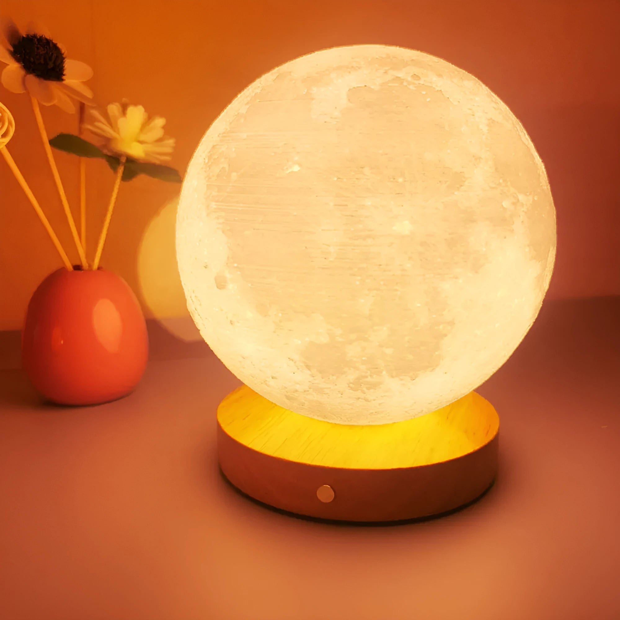 Rotating moon night light on a wooden base with a wire remote, shown in three available sizes.