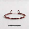 Hand-woven garnet bracelet with red rope and flexible wire construction showing national tide style