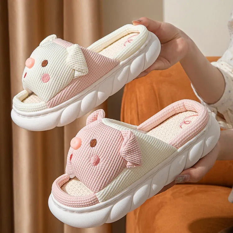 White linen open toe flip flop slippers for couples on a light background, showing PVC sole and strap detail.