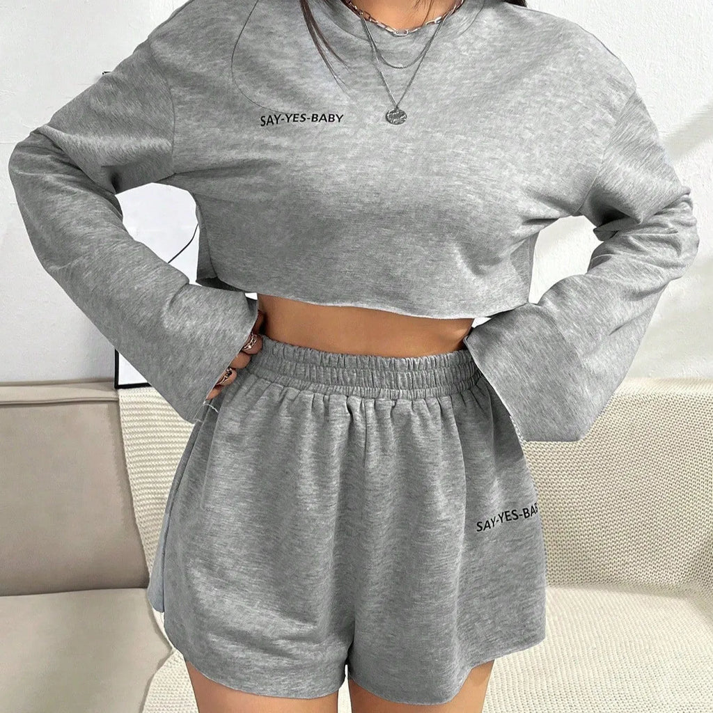 Grey women's long-sleeved T-shirt and matching shorts lounge set laid flat