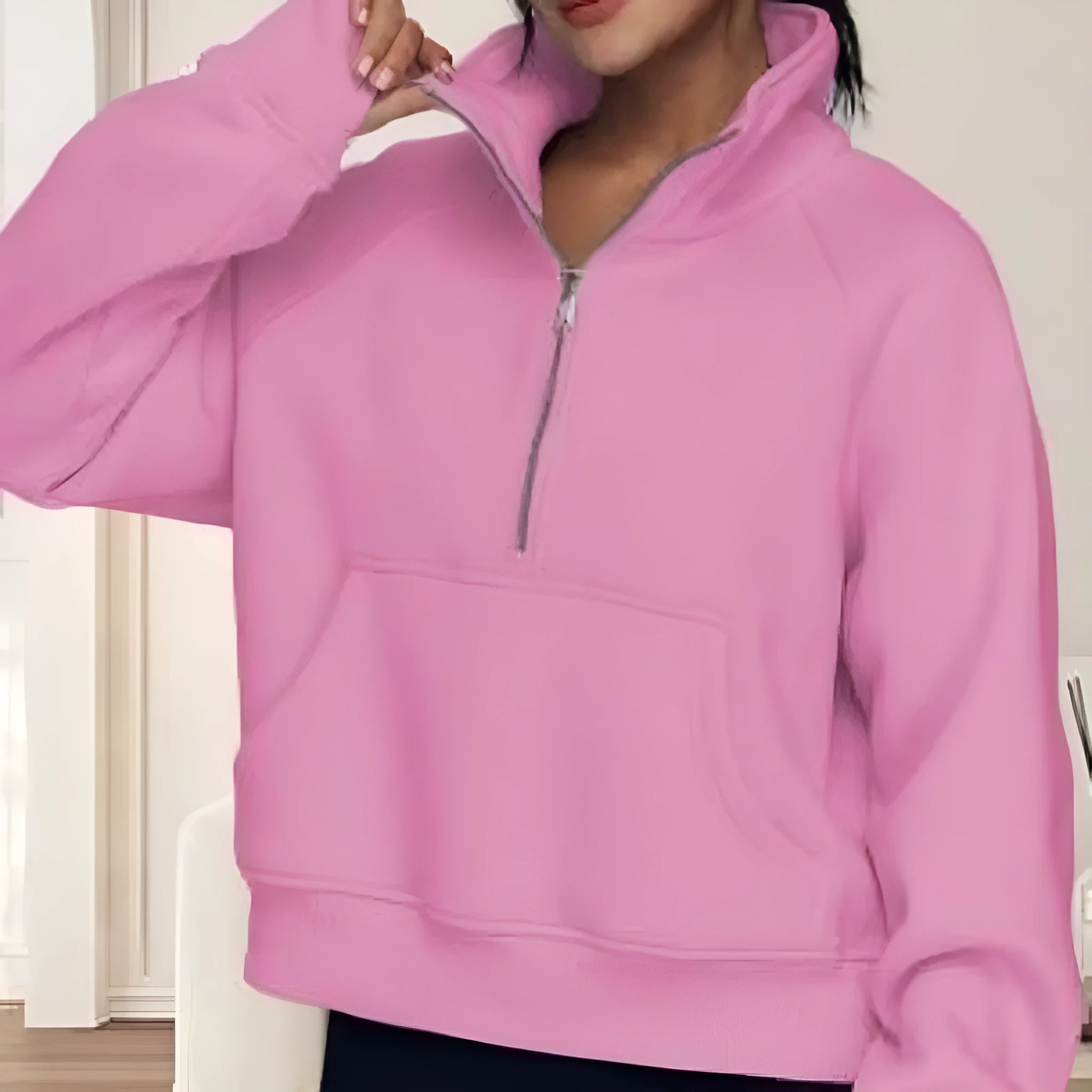 Woman wearing a loose lapel fleece-lined sweater in a solid colour, showing raglan sleeve detail.