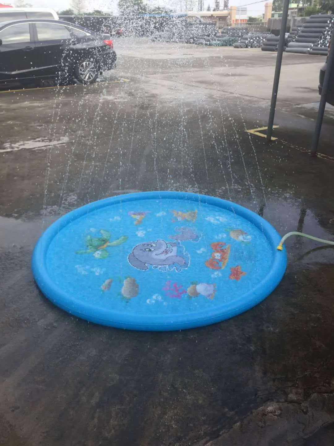 Blue PVC children's water spray play mat with marine animal designs measuring 100cm by 170cm