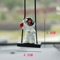 Resin astronaut car pendant with red flag, telescope, and radish designs
