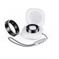 Black ceramic smart ring for health monitoring on a finger, showing a charging case accessory.