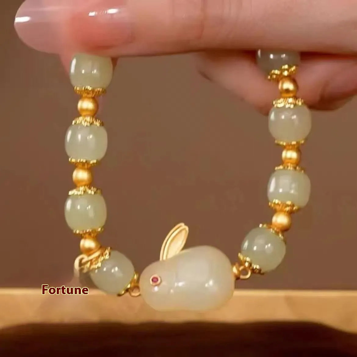 Green electroplated bracelet with a Chinese style hare charm and lily decoration for women.