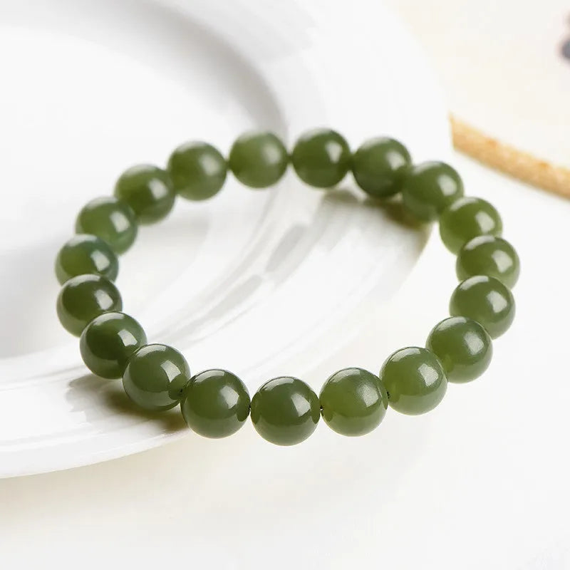 Hand-polished Hetian jade ball bracelet on wrist, showing deep water clear beads.