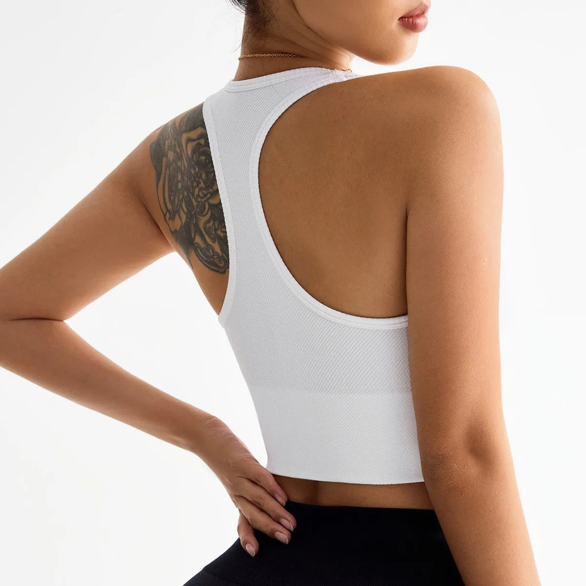 Black cross-back sports bra with moulded cups and fixed double straps on a mannequin