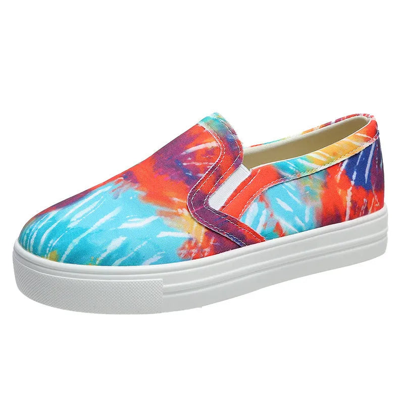 Women's low-top canvas slip-on shoes in colour matching pattern with rubber sole.