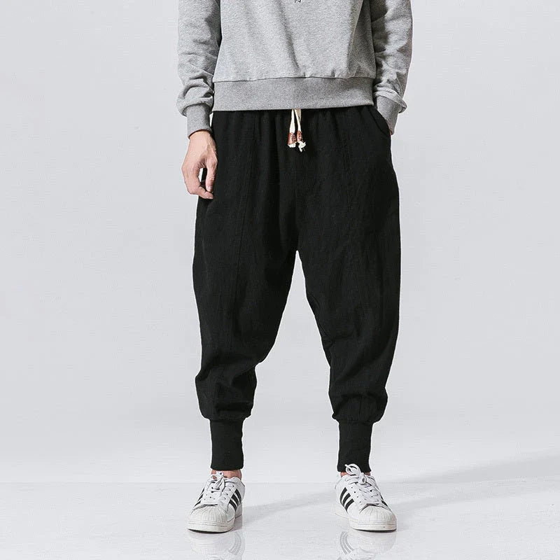 Comfortable linen and cotton harem pants for men, featuring an elastic waistband and a relaxed, trendy silhouette