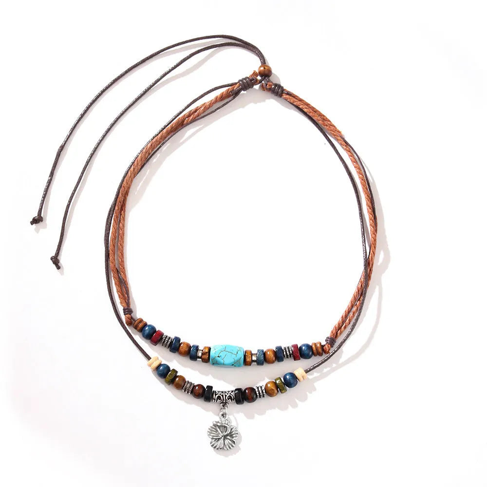 Men's turquoise wooden bead necklace with geometric alloy pendant on cream wax rope