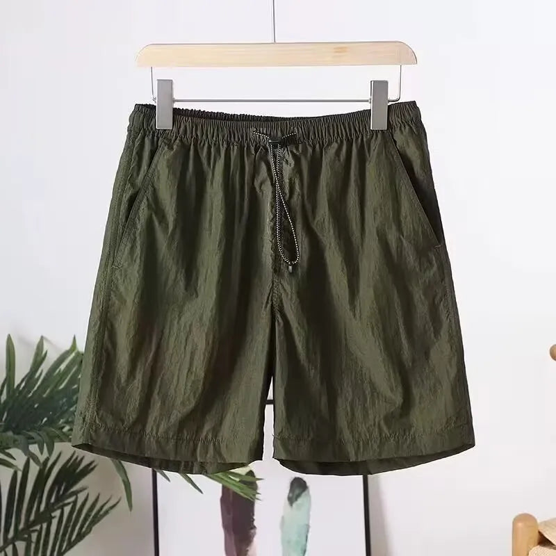 Men's straight-leg quick-dry sports shorts in grey on a hanger