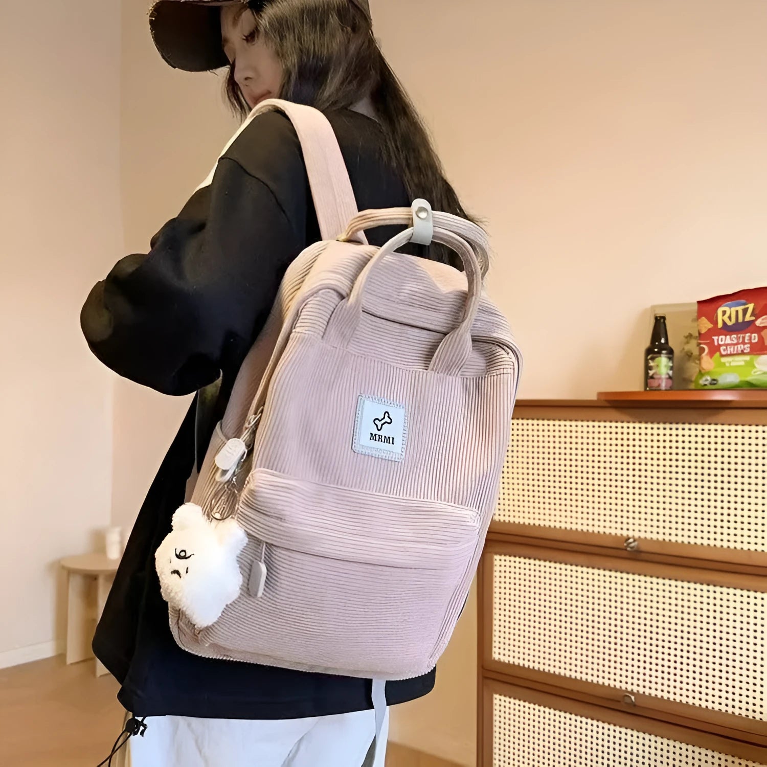 Retro hand-carrying backpack in light pink with breathable fabric, document pocket, and sewing line details for school use.