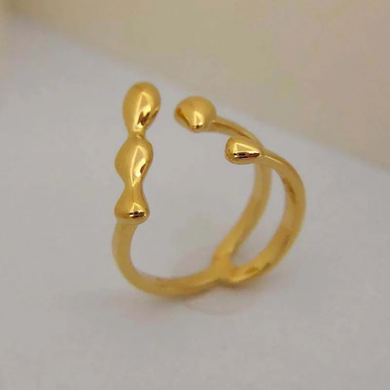 Brass opening ring for women with spherical design in gold or silver finish.